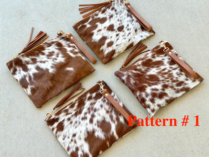 Handcrafted genuine cowhide crossbody purse with hair-on-hide front, leather tassel, adjustable strap, and western leather design for everyday wear, travel, rodeos, and concerts.