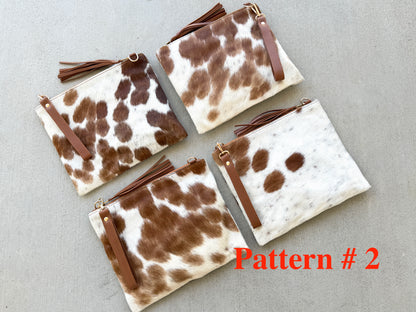 Handcrafted genuine cowhide crossbody purse with hair-on-hide front, leather tassel, adjustable strap, and western leather design for everyday wear, travel, rodeos, and concerts.