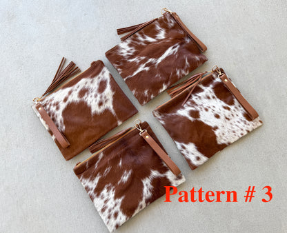 Handcrafted genuine cowhide crossbody purse with hair-on-hide front, leather tassel, adjustable strap, and western leather design for everyday wear, travel, rodeos, and concerts.