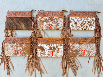 Handcrafted genuine cowhide crossbody bag with floral tooled leather, long leather fringe, adjustable strap, and zip-top closure for western, rodeo, and everyday style.