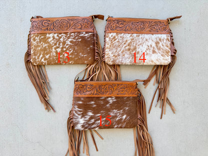 Handcrafted genuine cowhide crossbody bag with floral tooled leather, long leather fringe, adjustable strap, and zip-top closure for western, rodeo, and everyday style.