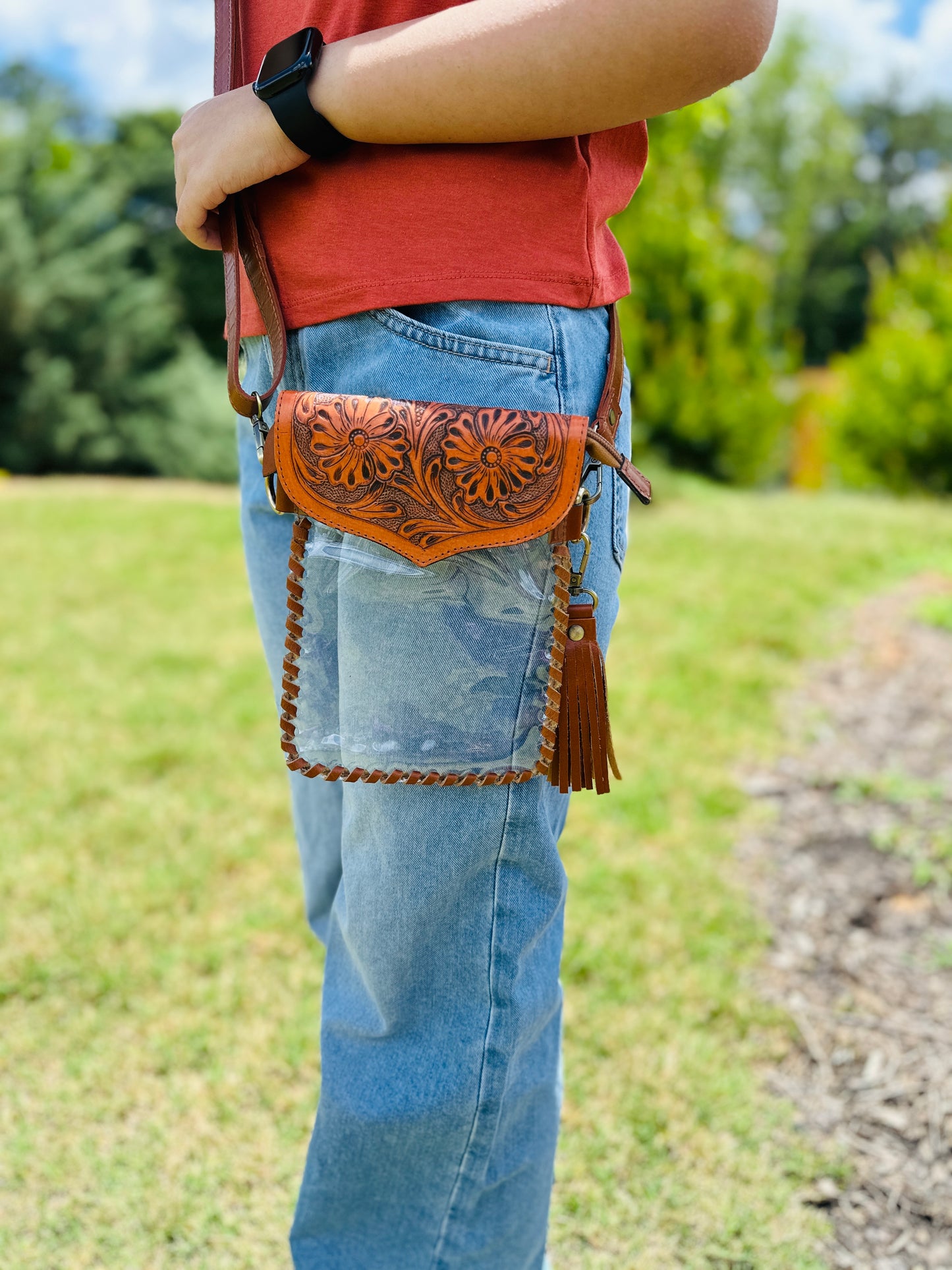 Handcrafted clear crossbody bag with genuine tooled leather accents. Stadium-approved western concert purse, perfect for rodeos, games, festivals, and everyday use.