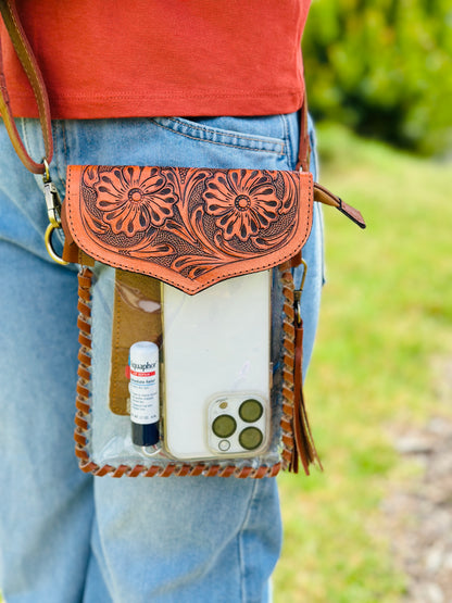 Handcrafted clear crossbody bag with genuine tooled leather accents. Stadium-approved western concert purse, perfect for rodeos, games, festivals, and everyday use.