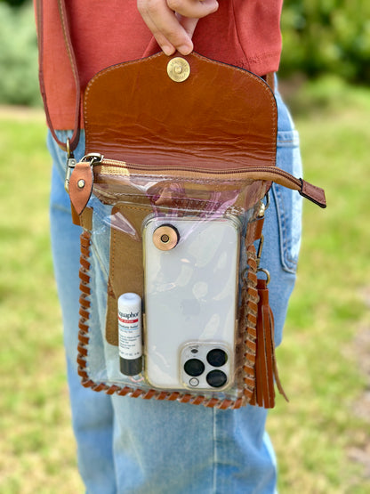 Handcrafted clear crossbody bag with genuine tooled leather accents. Stadium-approved western concert purse, perfect for rodeos, games, festivals, and everyday use.