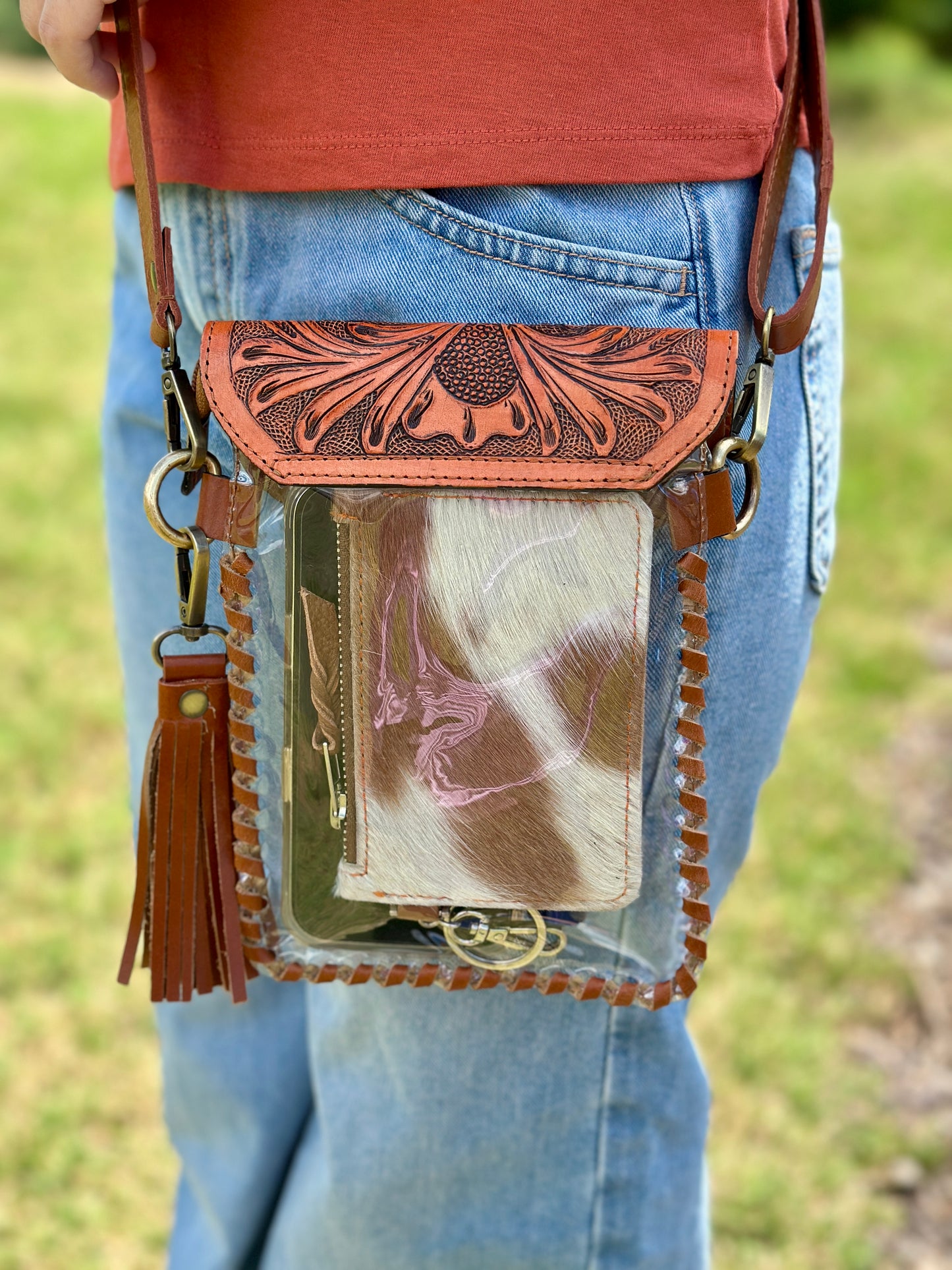 Handcrafted clear crossbody bag with genuine tooled leather accents. Stadium-approved western concert purse, perfect for rodeos, games, festivals, and everyday use.