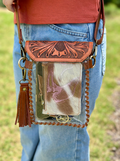 Handcrafted clear crossbody bag with genuine tooled leather accents. Stadium-approved western concert purse, perfect for rodeos, games, festivals, and everyday use.