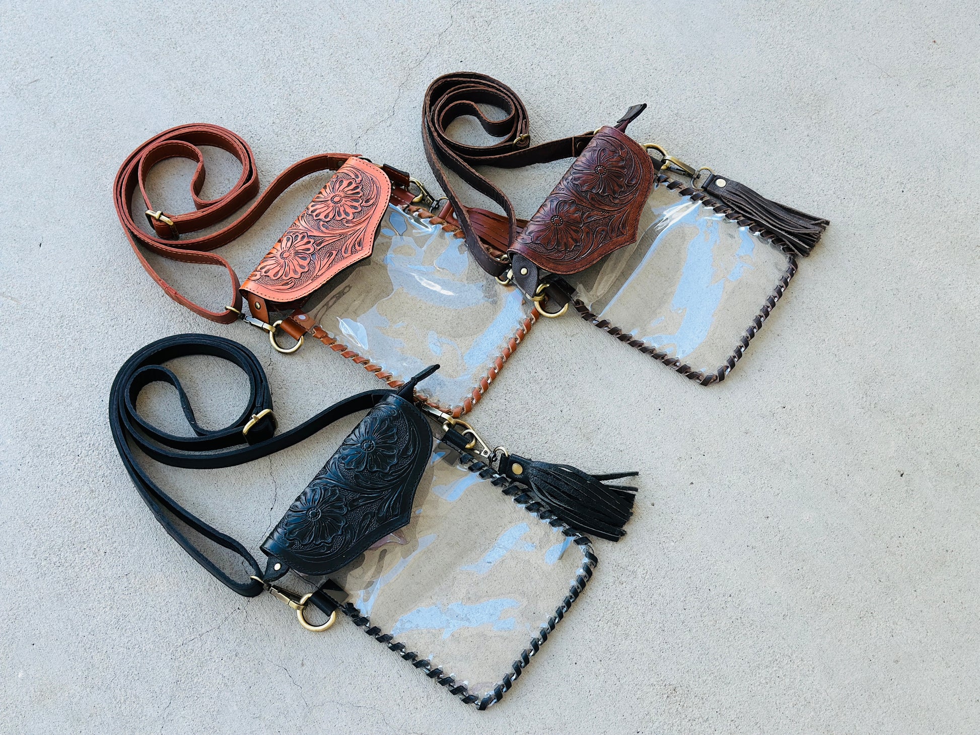 Handcrafted clear crossbody bag with genuine tooled leather accents. Stadium-approved western concert purse, perfect for rodeos, games, festivals, and everyday use.