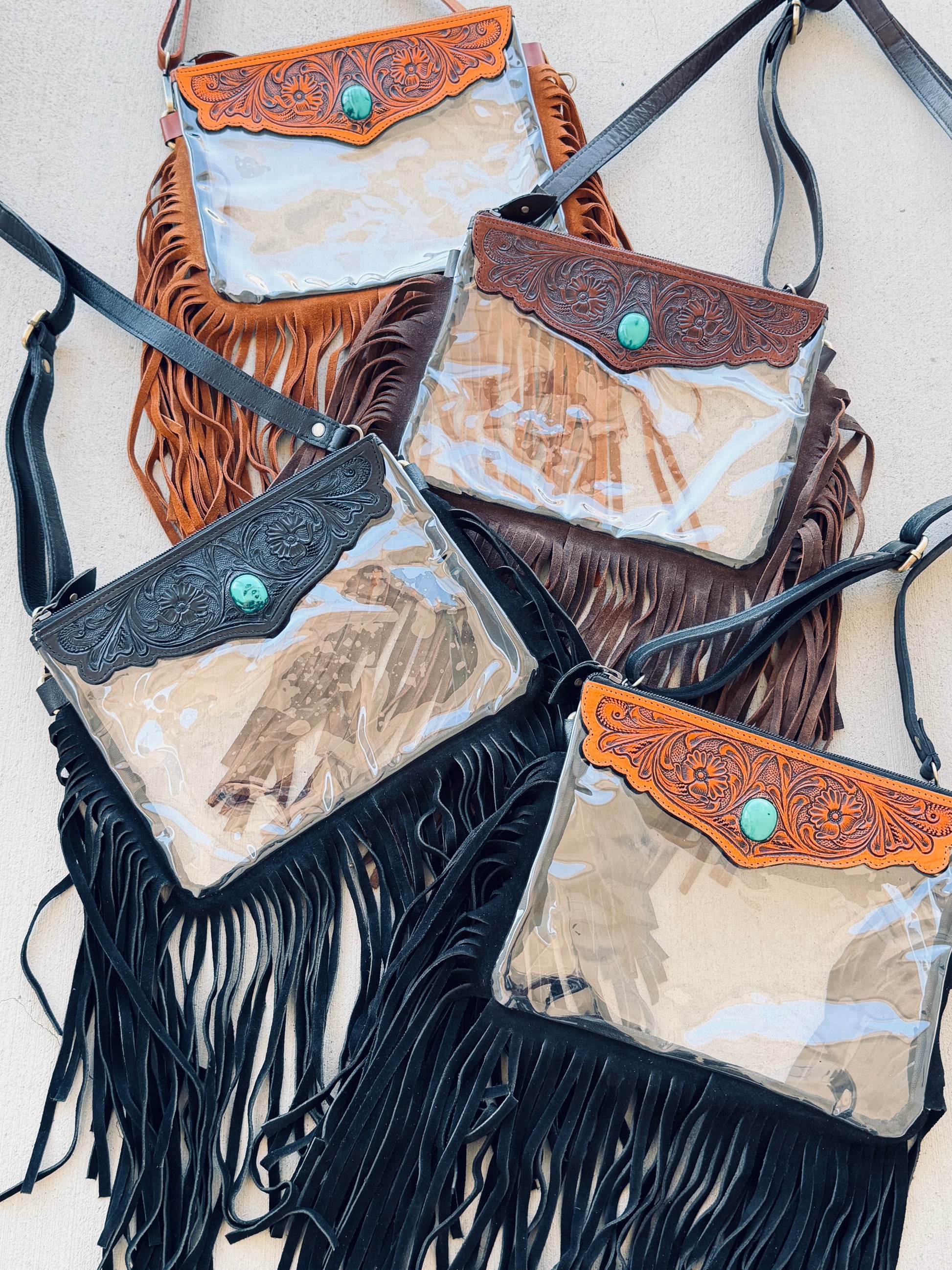 Stadium-approved clear western crossbody bag with genuine leather fringe, turquoise stone accent, adjustable strap, and zip closure for concerts, rodeos, and festivals.