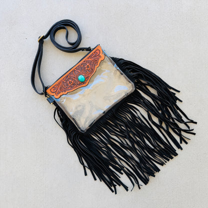 Stadium-approved clear western crossbody bag with genuine leather fringe, turquoise stone accent, adjustable strap, and zip closure for concerts, rodeos, and festivals.