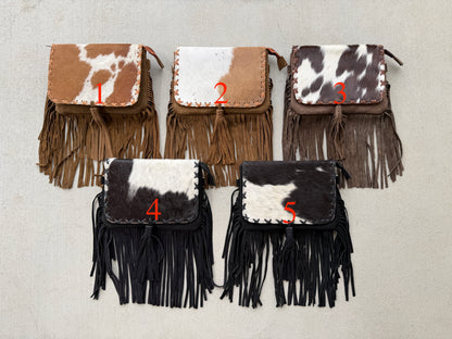 Handcrafted genuine cowhide fringe crossbody purse with whipstitched flap, leather tassel, adjustable strap, and western hair-on-hide design for rodeos, concerts, and everyday wear.