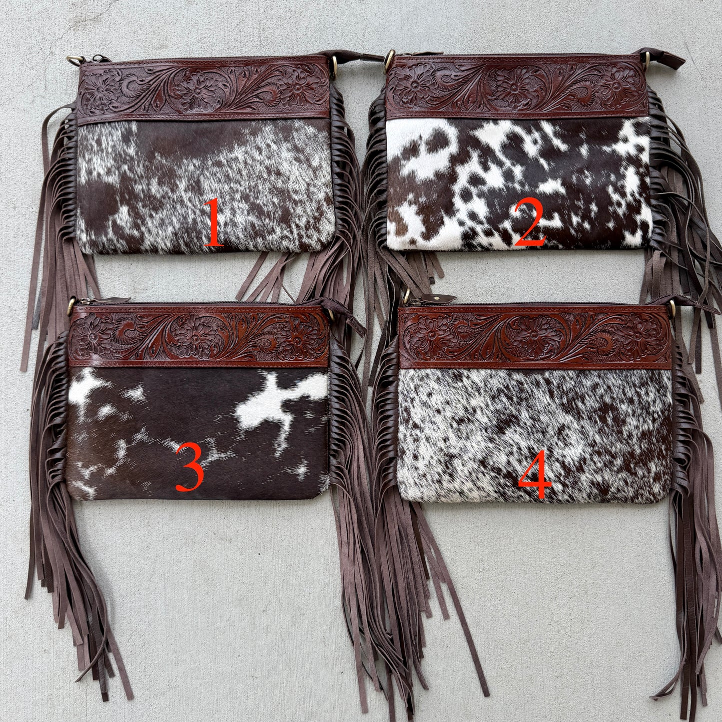 Handcrafted genuine cowhide crossbody bag with floral tooled leather, long leather fringe, adjustable strap, and zip-top closure for western, rodeo, and everyday style.