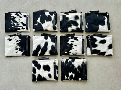 Handcrafted genuine cowhide crossbody purse with hair-on-hide front, leather tassel, adjustable strap, and western leather design for everyday wear, travel, rodeos, and concerts.