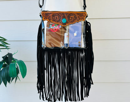 Stadium-approved clear western crossbody bag with genuine leather fringe, turquoise stone accent, adjustable strap, and zip closure for concerts, rodeos, and festivals.