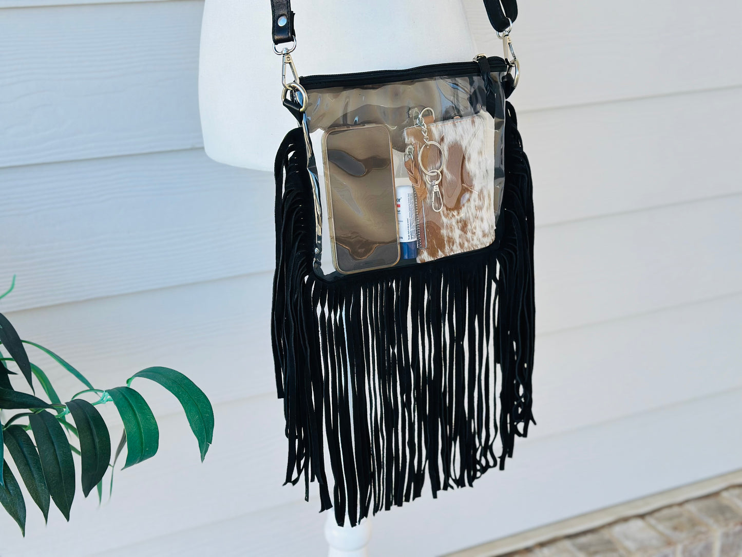 Stadium-approved clear western crossbody bag with genuine leather fringe, turquoise stone accent, adjustable strap, and zip closure for concerts, rodeos, and festivals.
