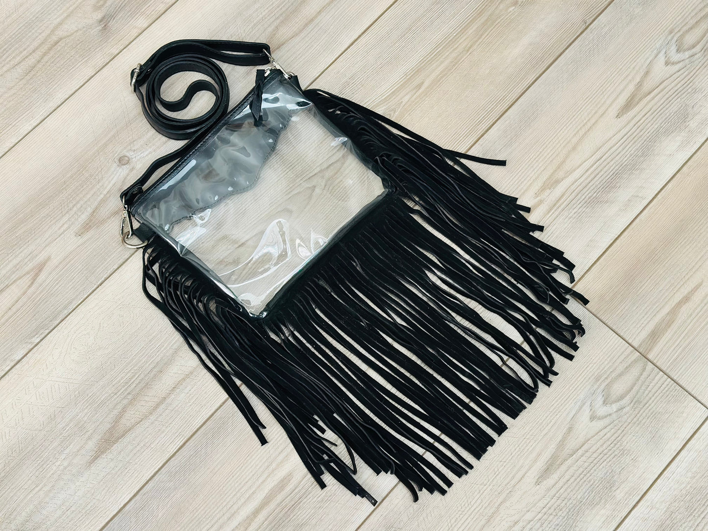 Stadium-approved clear western crossbody bag with genuine leather fringe, turquoise stone accent, adjustable strap, and zip closure for concerts, rodeos, and festivals.