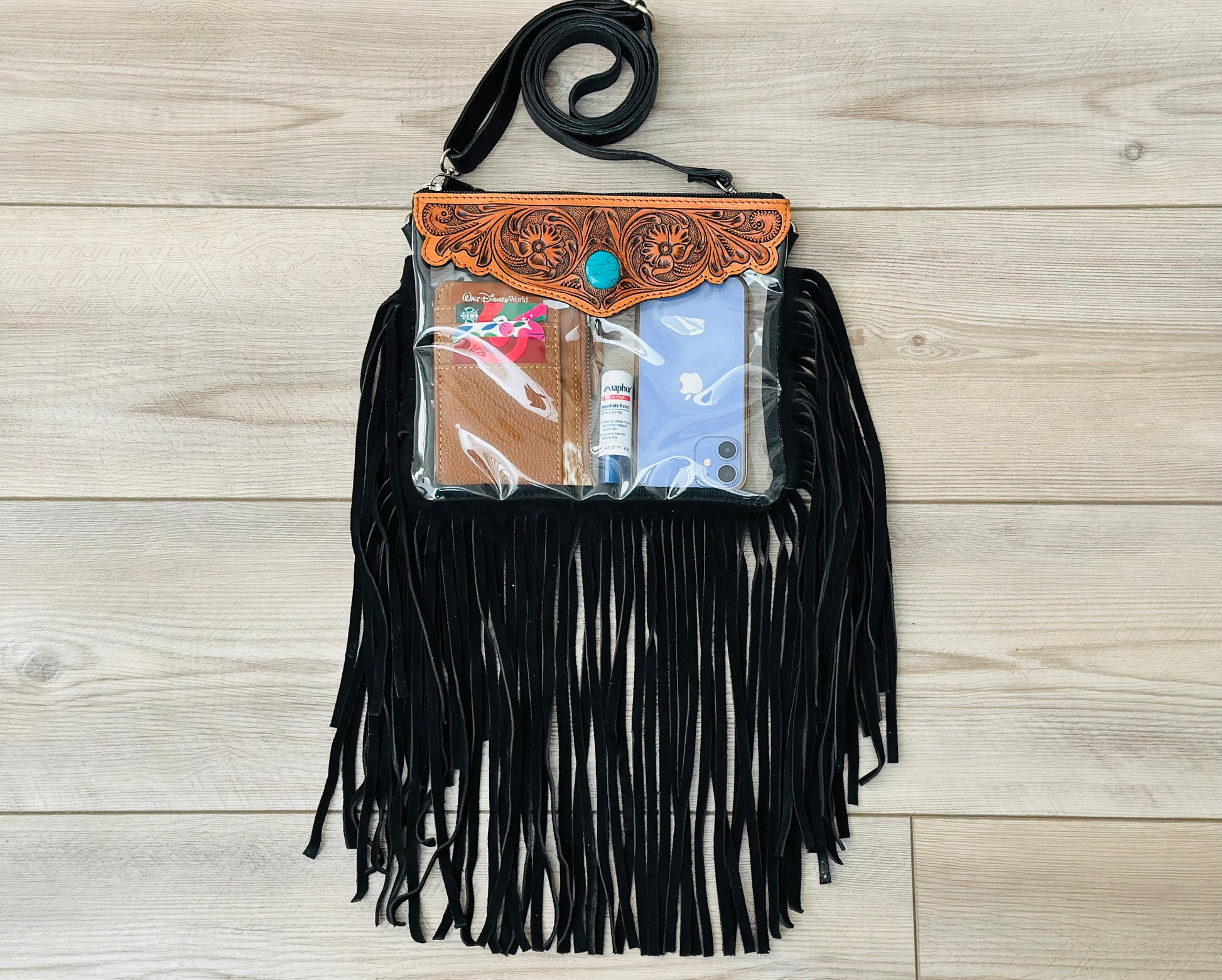 Stadium-approved clear western crossbody bag with genuine leather fringe, turquoise stone accent, adjustable strap, and zip closure for concerts, rodeos, and festivals.