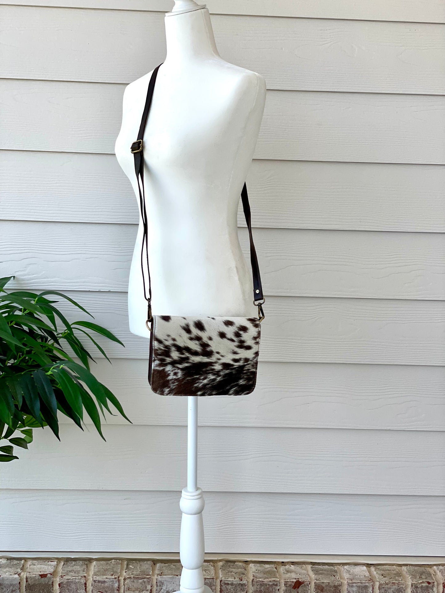 Handcrafted genuine cowhide leather crossbody purse with adjustable strap, western hair-on-hide handbag for rodeos, festivals, concerts, and everyday wear.
