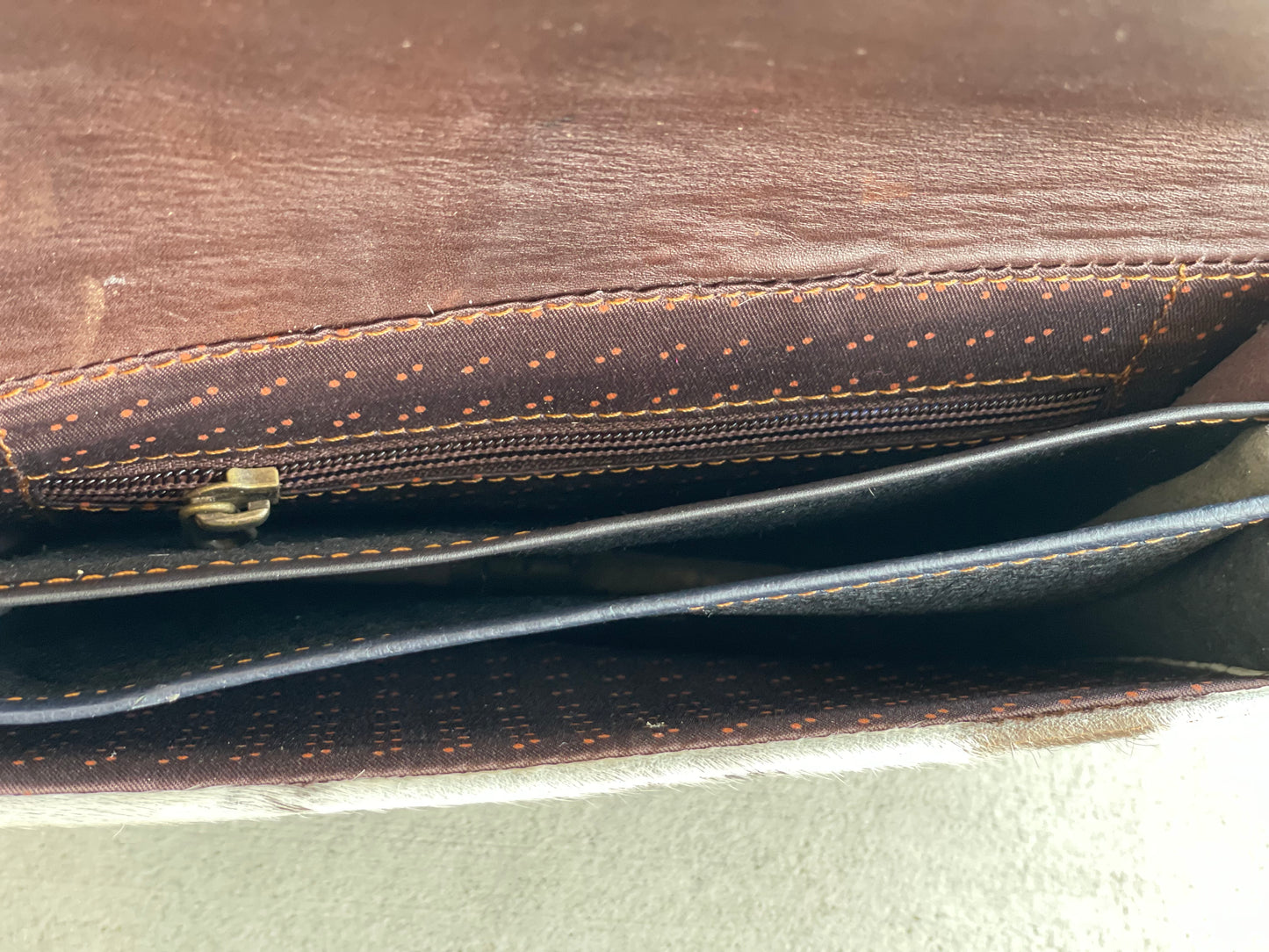 Handcrafted genuine cowhide leather crossbody purse with adjustable strap, western hair-on-hide handbag for rodeos, festivals, concerts, and everyday wear.