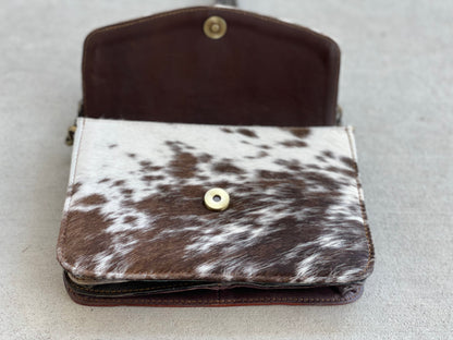 Handcrafted genuine cowhide leather crossbody purse with adjustable strap, western hair-on-hide handbag for rodeos, festivals, concerts, and everyday wear.