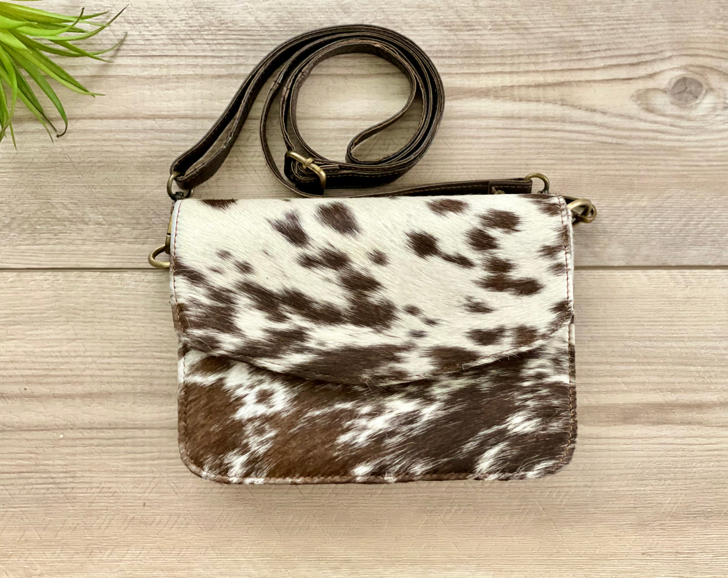 Handcrafted genuine cowhide leather crossbody purse with adjustable strap, western hair-on-hide handbag for rodeos, festivals, concerts, and everyday wear.