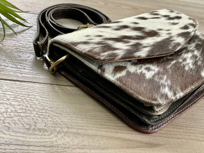 Handcrafted genuine cowhide leather crossbody purse with adjustable strap, western hair-on-hide handbag for rodeos, festivals, concerts, and everyday wear.