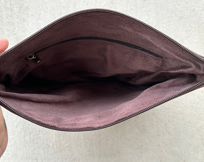 Handcrafted genuine cowhide crossbody purse with floral tooled leather zipper accent, adjustable leather strap, and western hair-on-hide design for everyday wear and rodeos.