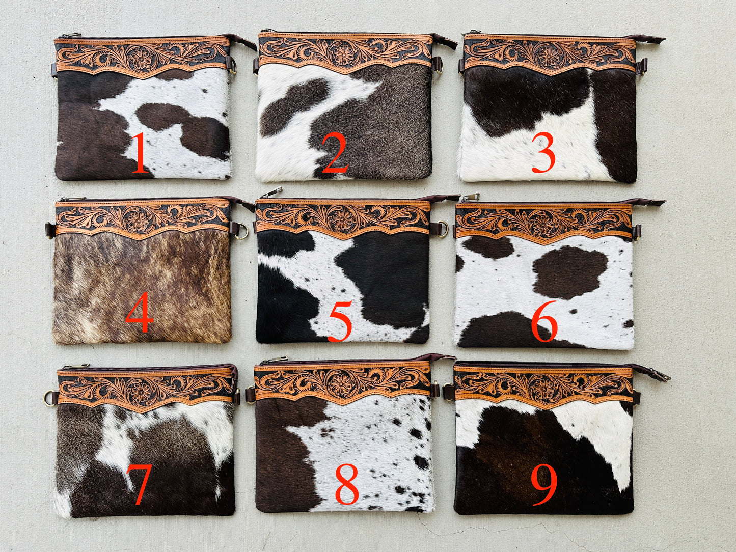 Handcrafted genuine cowhide crossbody purse with floral tooled leather zipper accent, adjustable leather strap, and western hair-on-hide design for everyday wear and rodeos.