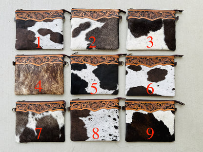Handcrafted genuine cowhide crossbody purse with floral tooled leather zipper accent, adjustable leather strap, and western hair-on-hide design for everyday wear and rodeos.