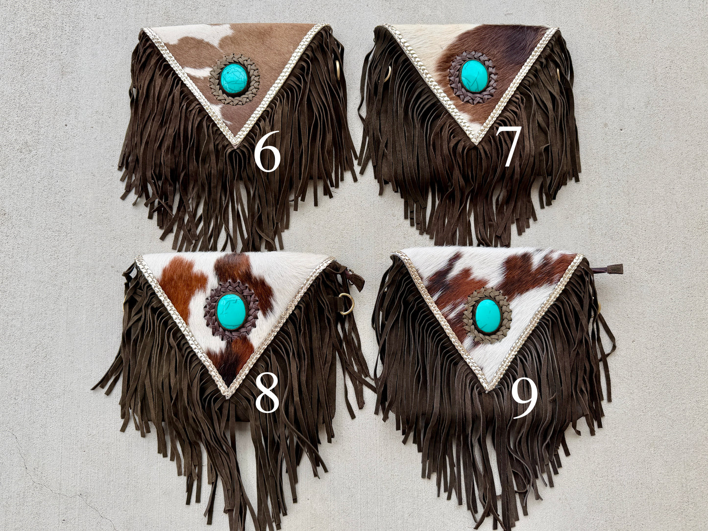 Handcrafted western cowhide crossbody bag with turquoise stone concho, whipstitched envelope flap, long leather fringe, and adjustable strap for rodeos, concerts, and everyday wear.