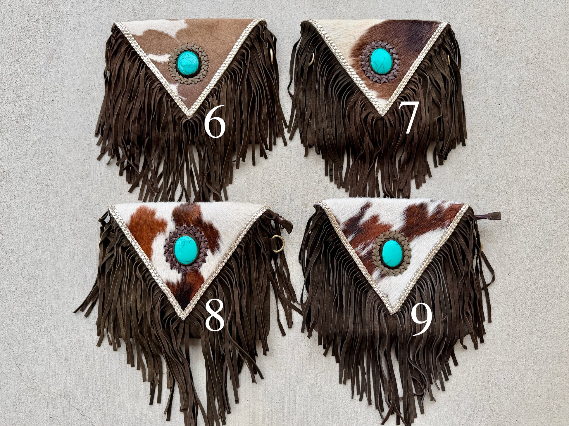 Handcrafted western cowhide crossbody bag with turquoise stone concho, whipstitched envelope flap, long leather fringe, and adjustable strap for rodeos, concerts, and everyday wear.