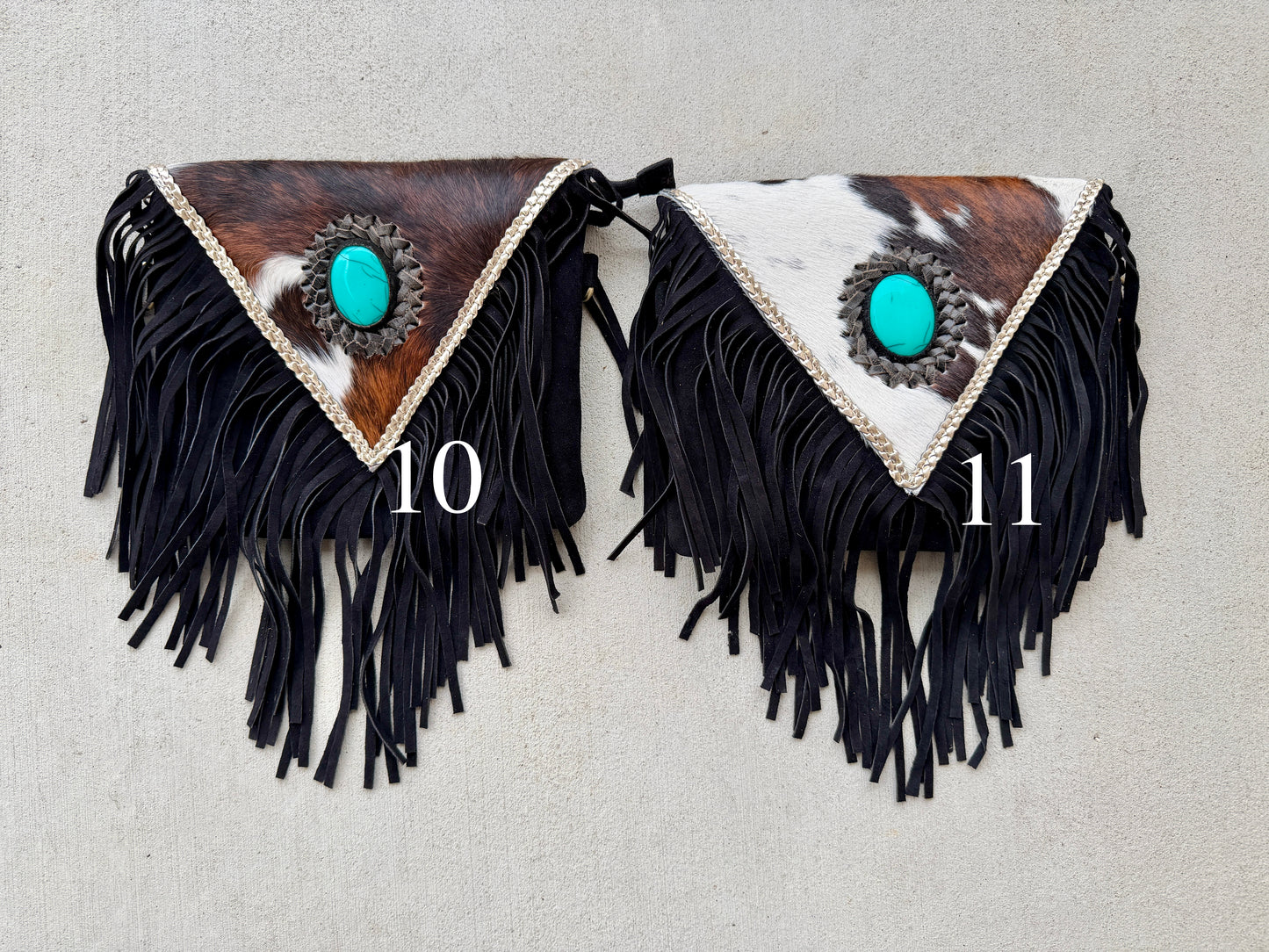 Handcrafted western cowhide crossbody bag with turquoise stone concho, whipstitched envelope flap, long leather fringe, and adjustable strap for rodeos, concerts, and everyday wear.