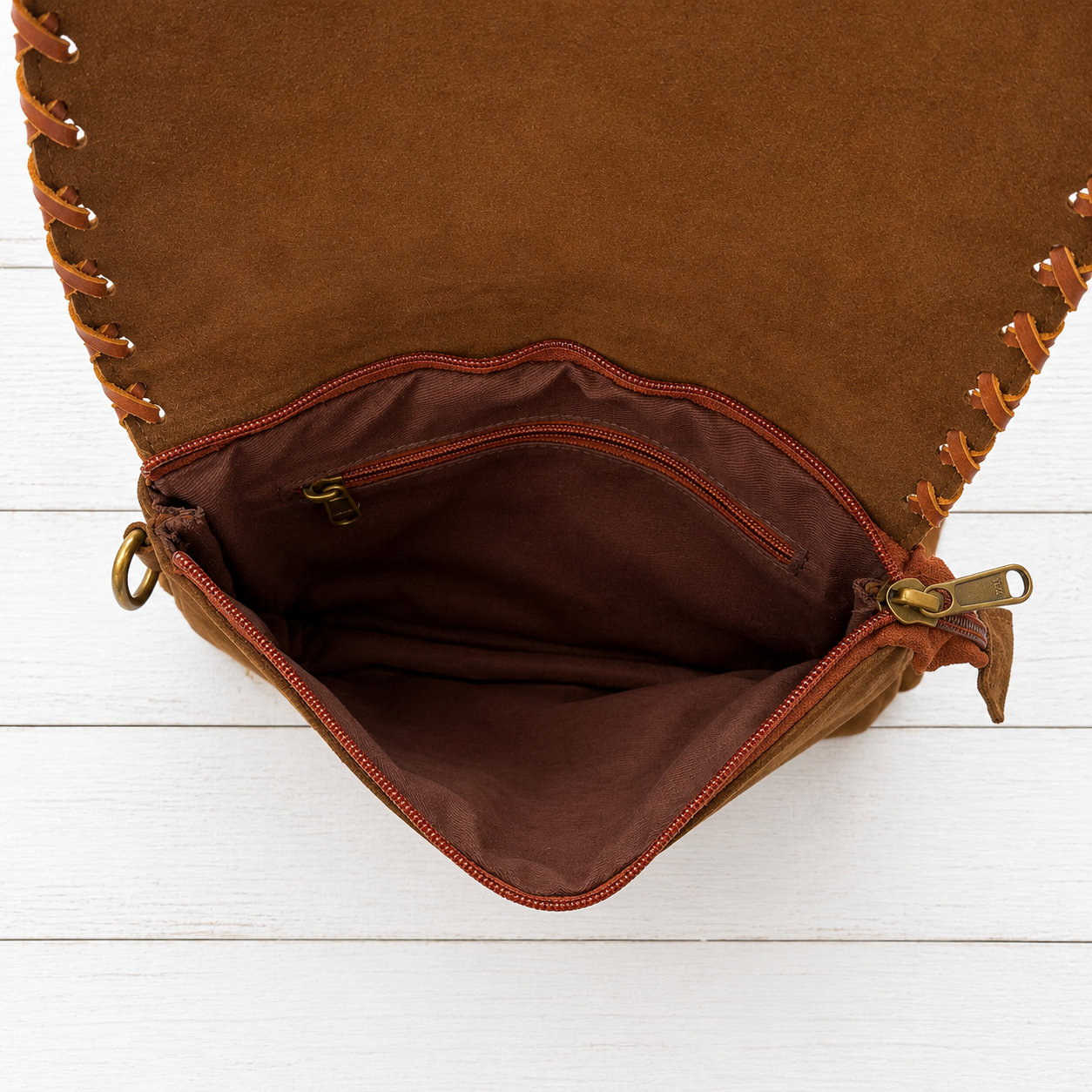 Handcrafted genuine cowhide fringe crossbody purse with whipstitched flap, leather tassel, adjustable strap, and western hair-on-hide design for rodeos, concerts, and everyday wear.